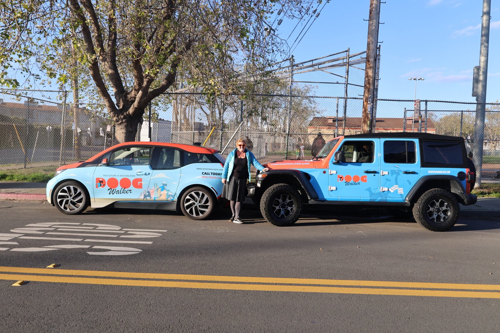 The Doog Walker branded vehicles parked in Marin County, showcasing our professional group dog walking service and safe transportation program.