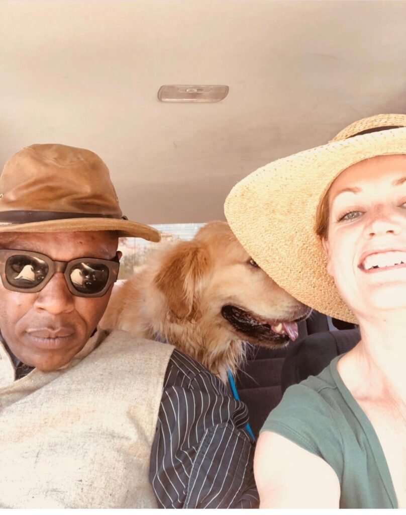 The Doog Walker founders smiling in their vehicle with a golden retriever during a day of dog adventures in Marin County.